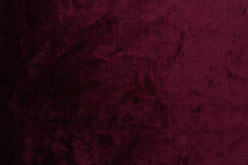 Obraz premium Dark red purple crushed velvet texture background, luxury burgundy velour fabric with soft shiny pattern.