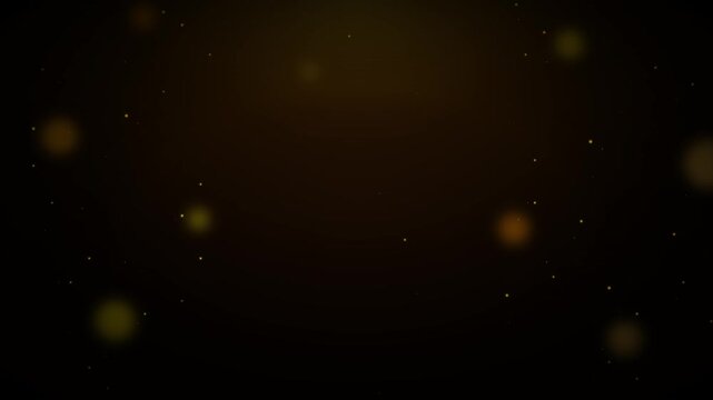Dark background with glowing golden particles and soft bokeh light effects abstract