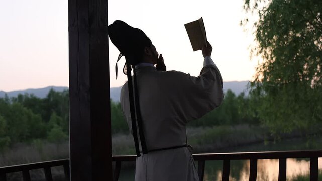 he silhouette of Li Bai, the great poet of the Tang Dynasty in China, reading by a lake