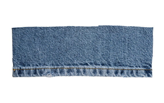 Blue denim fabric texture with seam, classic jeans cloth background with yellow stitching and frayed edge.
