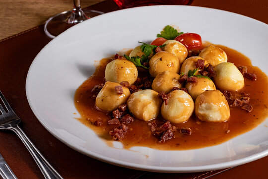 Gourmet Potato Gnocchi in Savory Sauce with Crispy Bacon and Portuguese Ros&eacute; Wine