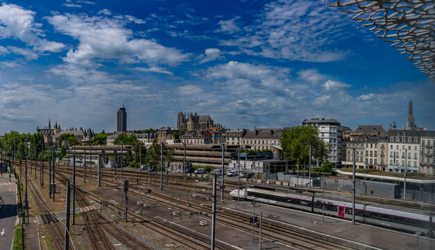 Nantes, France - 05 09 2026: Nantes railroad station. Panoramic view of the city's main monuments and the railway lines in front, from inside the station and a sunny blue sky