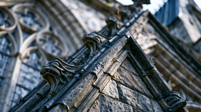 Gothic cathedral flying buttress stonework detail, limestone pinnacle mass weighted above springer course, carved grotesque waterspout gargoyle projecting from parapet, medieval masonry joint lead f