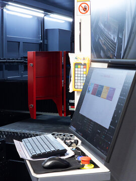 Modern CNC Laser Cutting Machine Operator Control Panel with Software Interface and Monitors