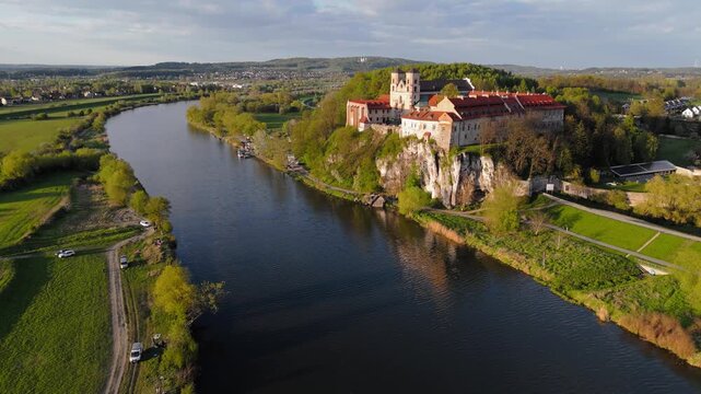 An aerial flyover of Tyniec Abbey in Poland at sunset on a spring evening.