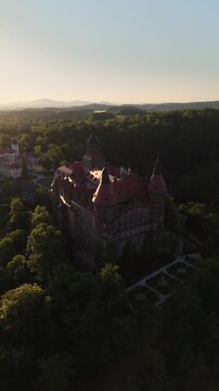 Aerial flyover of Walbrzych Castle in Poland at sunset in the spring.