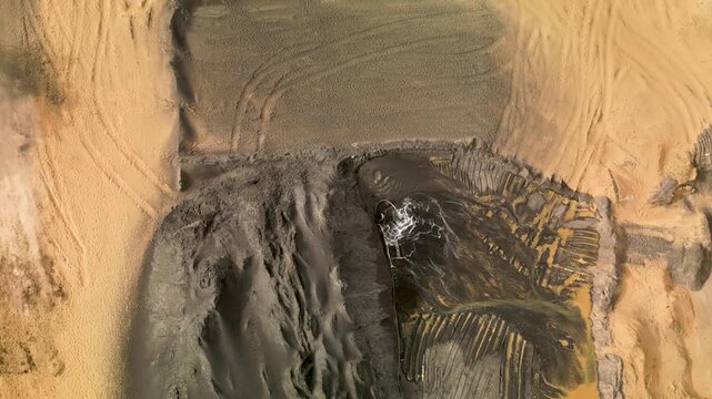 aerial top down view of open pit zircon mine in Abene in Sengal in Africa, exploitation of resources in natural protected area