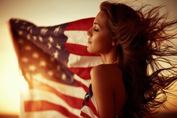 Naklejka premium Young woman with windblown hair embraces the American flag at sunset, symbolizing freedom and patriotism.