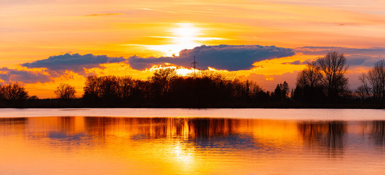 Summer sunset or sundowner view with reflections near Plattling, Isar, Deggendorf, Bavaria, Germany