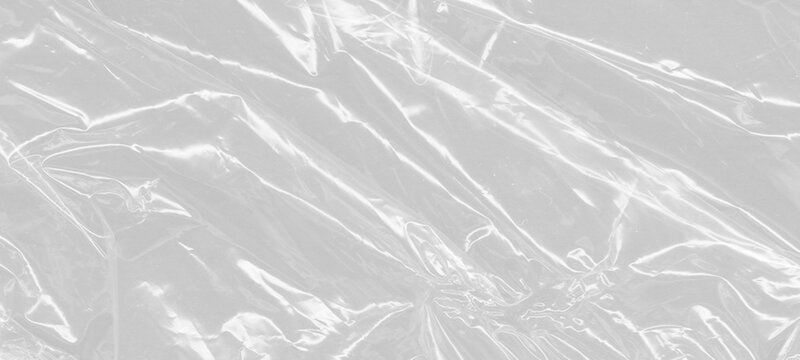 Diagonal creases in clear plastic film create dynamic lines across white background making it perfect for creative overlays and texturing graphic resources with realistic crinkled material look