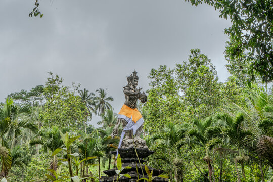 Indonesian statue in a temple with offerings