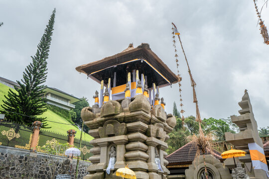 Indonesian statue in a temple with offerings