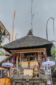 Indonesian statue in a temple with offerings