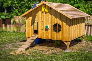 Chicken coop in a garden with green grass © Brebca