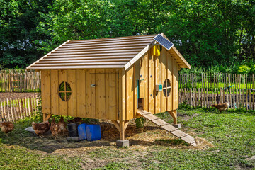 Chicken coop in a garden with green grass © Brebca
