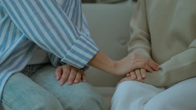 Close Up of Hands Providing Emotional Comfort and Support During Counseling Session.  Empathy touch and emotional healing support