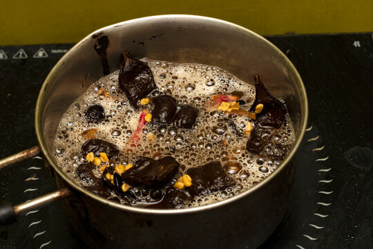 Homemade Herbal Shampoo Ingredients Boiling in Pan on Induction Cooktop