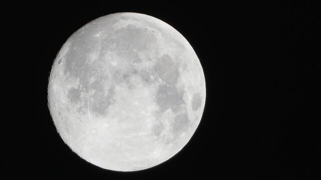 Moon astronomy space capturing a detailed view of the lunar surface with craters and highlights against the pitch black night sky