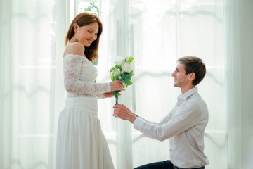 Naklejka premium On Valentine's Day transgender men and women express their love by kneeling and presenting bouquet white roses wedding ceremony symbolizing equality and profound love.