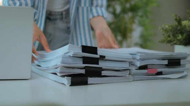 Close Up of Tall Stack of Document Files and Folders Piled on Office Desk. Heavy Workload and Busy Professional Work Environment.