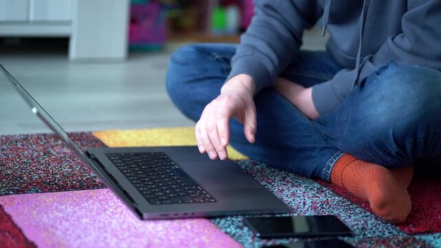 A man sits in a yoga pose on a mat near a laptop, gesturing with frustration and swiping the touchpad, blending wellness with remote work stress. WFH humor content, ergonomic PSA visuals, digital