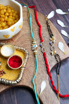 Indian festival Raksha bandhan. Rakhi thali with diya, flowers and tilak with sweet boondi or bundi. Puja thali for rakhi festival with roli chawal. copy space. also known as Narali Purnima. 
