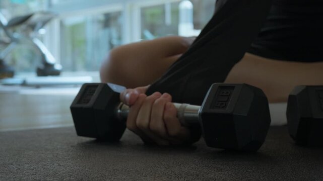Two Dumbbells on Gym Floor. Close-Up of Free Weights in Fitness Center