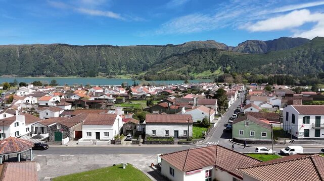 Aerial drone view of Sete Cidades village and its traditional white houses. Scenic volcanic valley landscape overlooking the twin lakes on Sao Miguel Island, Azores, Portugal Europe