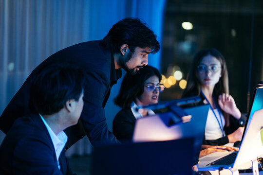 Professional team check financial data on computer screen. Diverse corporate specialist group work together on network system concept. Executive man lead serious business solution meeting discussion