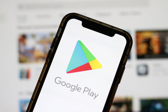 Google Play Store logo displayed on a smartphone screen with a blurred digital marketplace interface in the background.