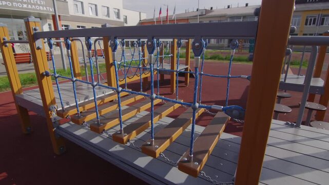 Empty balancing path stands ready for active children during school break. Safe design elements create engaging environment for play