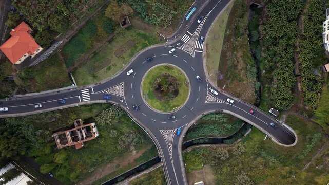 Aerial top-down view of traffic on a roundabout in Funchal, Madeira Island, Portugal.	