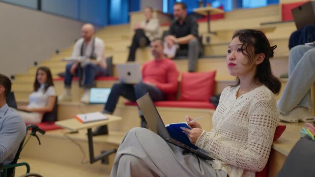 Diverse colleagues gather for an engaging workshop in a contemporary setting. Attentive employees participate in a collaborative learning session within a modern office