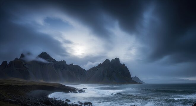 Sunrise over mountains with clouds in the sky and misty landscape