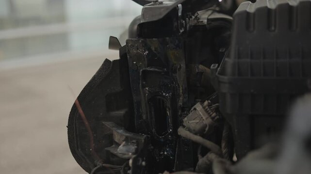 The front bumper has been completely removed to expose the inner mechanical and structural parts