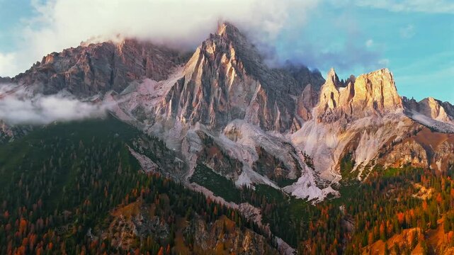 Aerial hyperlapse of high mountain peak with clouds in Dolomites, Italy