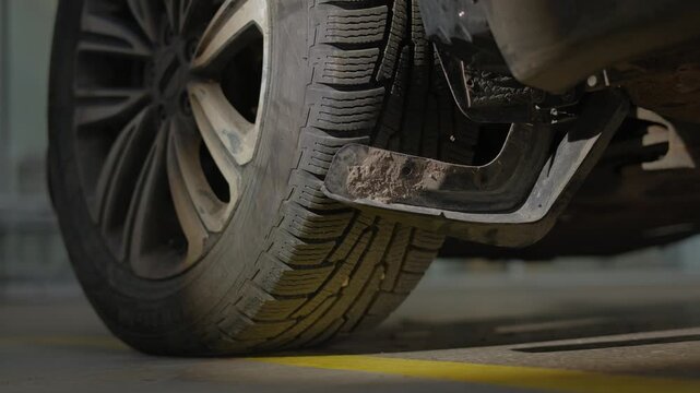 Professional auto body shop restores the vehicle's protection.The torn underbody part is replaced with a new one