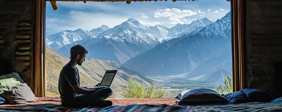 A serene mountain view with a freelancer working on a laptop, blending work and nature