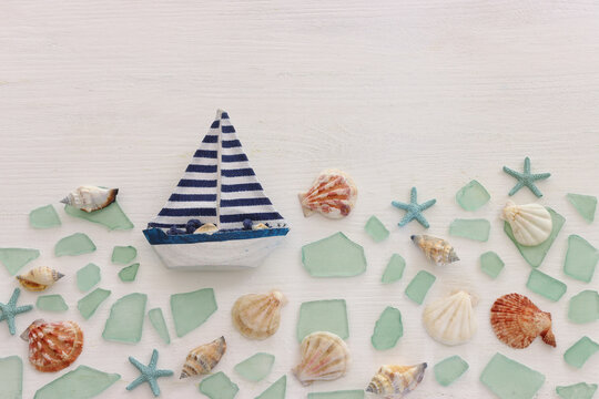 summer background with blue sea glass and shells