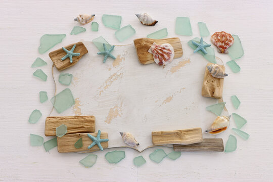 summer background with blue sea glass and shells