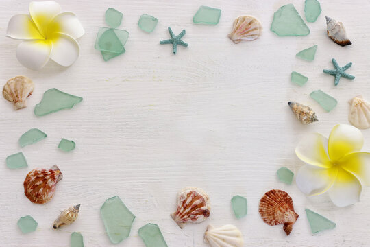 summer background with blue sea glass and shells