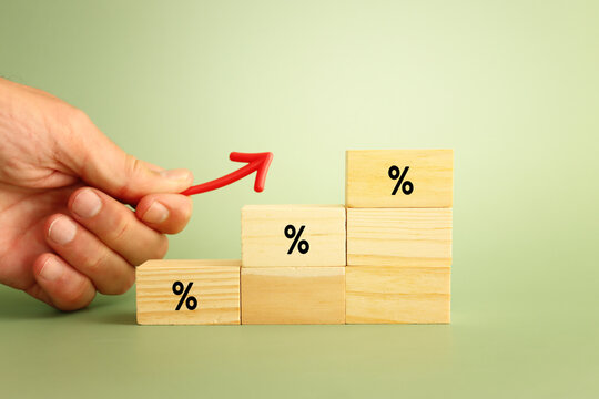 Wooden cubes with percentage sign going up, concept of business growth, finance and income increase
