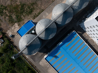 aerial view of industrial grain silos and blue roof factory buildings © zhu difeng