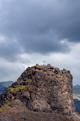 Fototapeta premium Small Mountain Peak with a Christian Cross in Agaete, Gran Canaria, Spain