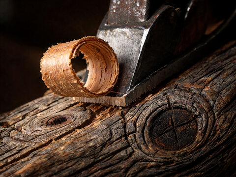 Wooden plane shaving raw walnut wood block
