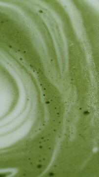 Vibrant green matcha cream texture in macro view with smooth movement for premium food branding.
