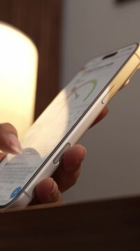 Close-up of a hand scrolling through a social media feed on a smartphone, depicting digital addiction, mindless browsing, and screen dependency in daily life.