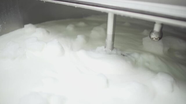 Boiling milk in a milk production tank.