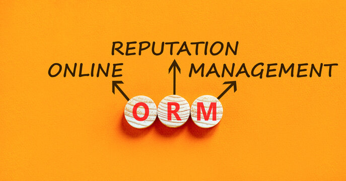 ORM online reputation management symbol. Concept words ORM online reputation management on beautiful wooden circles. Beautiful orange background. Business ORM concept. Copy space.