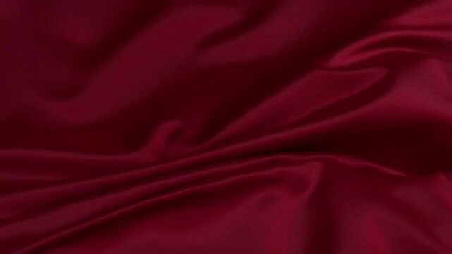 Luxurious red fabric rippling and flowing in gentle waves